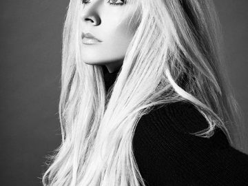 a monochrome portrait of a blonde woman looking away from the camera focus